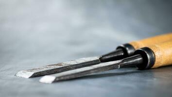 Chisel on wood on the table. photo