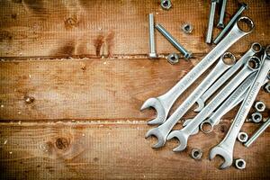 Wrenches with nuts on the table. photo