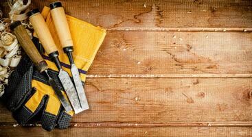 Chisels with wooden sawdust on the table. photo