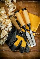 Chisels with wooden sawdust on the table. photo