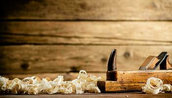 A planer with wooden shavings on the table. photo