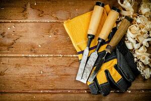 Chisels with wooden sawdust on the table. photo