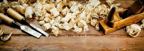 Working tool on wood on with shavings. photo