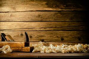 A planer with wooden shavings on the table. photo