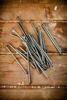 Nails on the table. On a wooden background. photo