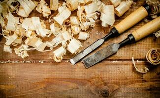 Chisels with wood chips on the table. photo