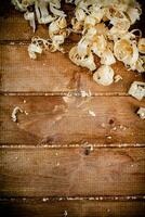 Wooden shavings on the table. On a wooden background. photo