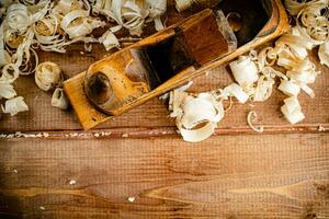 Working tool on wood on with shavings. photo