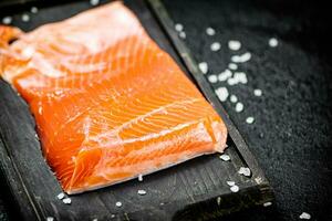 Delicious salted salmon on a cutting board. photo