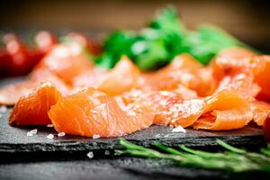 Fragrant salted salmon on a stone board. photo