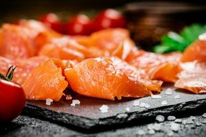 Fragrant salted salmon on a stone board. photo