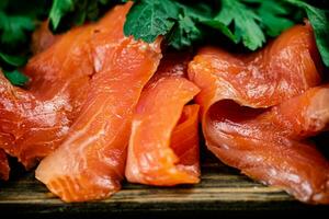 Pieces of salted salmon with parsley. photo