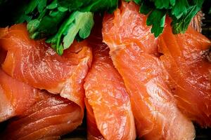 Pieces of salted salmon with parsley. photo