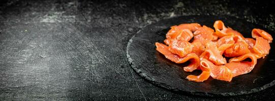 Salted salmon on a stone board. photo