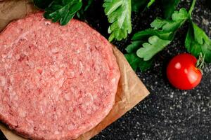 Raw burger with tomatoes and parsley. photo
