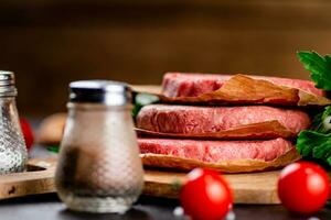 Raw burger with tomatoes and parsley. photo