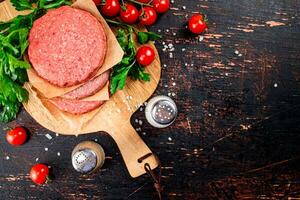 Raw burger with tomatoes and parsley. photo