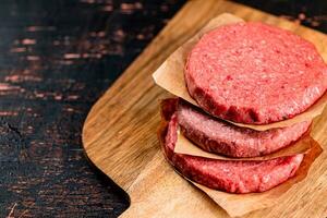 Raw burger on a cutting board. photo