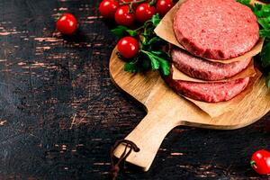 Raw burger with tomatoes and parsley. photo