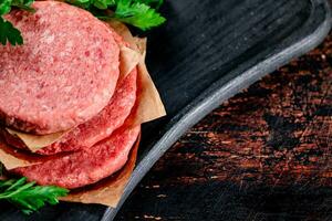 Raw burger with parsley. photo