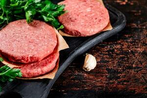 Raw burger with parsley. photo