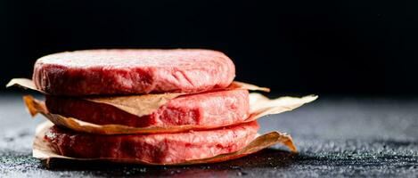 Pile raw burger on the table. photo