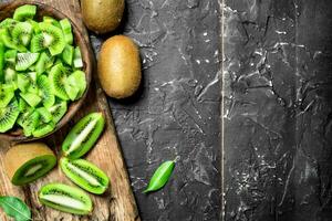 Kiwi slices in a bowl on a cutting Board. photo