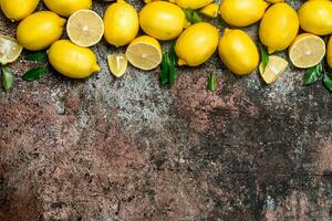 Fragrant fresh lemons with leaves. photo
