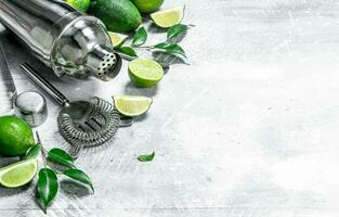 Shaker with pieces of juicy lime and leaves. photo