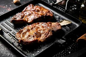 Grilled pork steak in a frying pan. photo