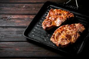 Grilled pork steak in a frying pan. photo