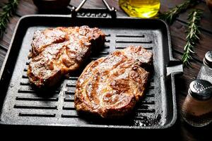 Grilled pork steak in a frying pan. photo