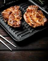 Grilled pork steak in a frying pan. photo