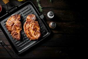 Grilled pork steak in a frying pan. photo