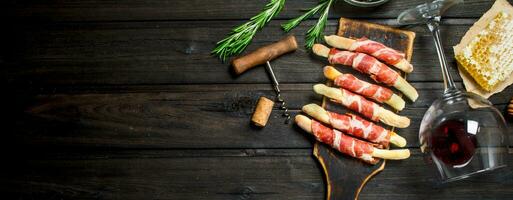 Meat appetizer on breadsticks with red wine. photo