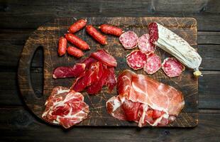 Antipasto background. Assortment of meat snacks on the Board . photo
