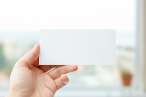 Male hand holding blank paper card photo