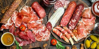 Antipasto background. Assortment of meat snacks on the Board . photo