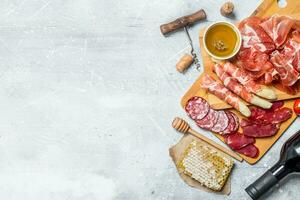 Antipasto background.Assortment of meat snacks with red wine. photo