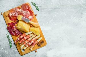 Antipasto background.Meat and cheese snacks on the Board. photo