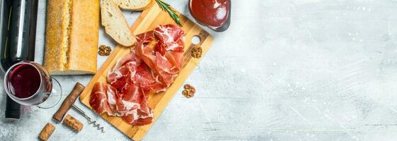 Traditional Spanish ham with ciabatta and red wine. photo