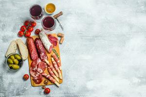 Antipasto background. Different Italian snacks with red wine. photo
