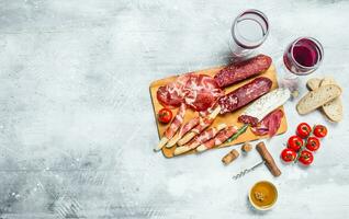 Antipasto background. Different Italian snacks with red wine. photo