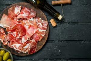 Spanish ham with red wine and breadsticks. photo