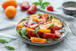 Green salad from leaves and tomatoes photo