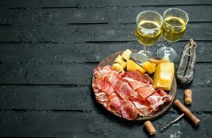 Antipasto background.Italian appetizers with white wine. photo