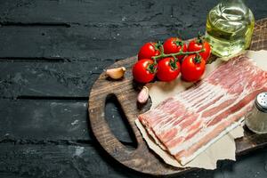 Raw bacon with tomatoes and spices. photo