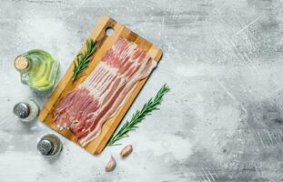 Raw bacon with herbs and spices. photo