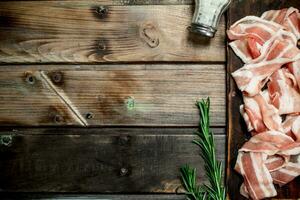 Raw bacon with spices and rosemary. photo