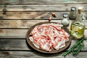 Raw bacon with rosemary and olive oil. photo